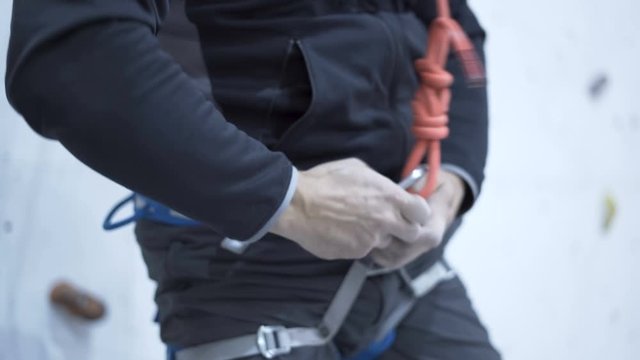 Climbers tying knots, preparing for climbing, belay line