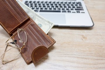 Top view, wallet with dollar and computer