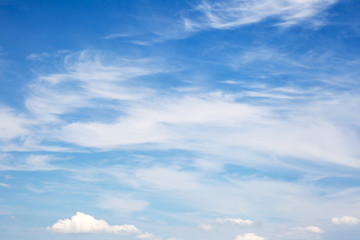 Background sky on a bright sunny day. Beautiful cumulus and cirrus thin clouds on a blue sky...