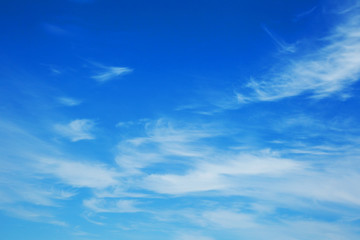 Naklejka na ściany i meble Background sky on a bright sunny day. Beautiful cumulus and cirrus thin clouds on a blue sky background. Blank for nature design