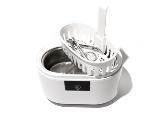 Cleaning systems for medical instruments. Ultrasonic cleaner on white background