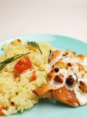 Grilled salmon with white rice on a plate on a white background. fish fillet with rice close up.
