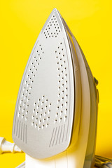 Electric Iron isolated on yellow background