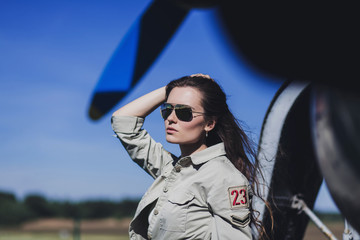 Fashion woman in military clothes and sunglasses outdoor