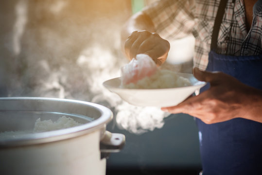 The Cook Is Scooping The Rice Onto A Dish And The Mass Of Steam Reflected In The Morning Light Coming Out Of A Large Electric Rice Cooker That Is Heated In The Cafeteria.