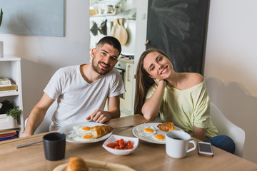 Obraz na płótnie Canvas romantic couple eating breakfast at home