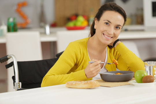 Happy Disable Woman Eating Pasta