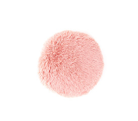 Round fluffy pink pillow isolated. Pink soft cushion against the white. One pillow with decorative fluffy case. Top view.