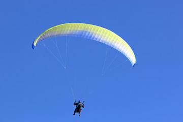 Paraglider flying wing in a blue sky