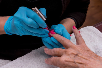 Close-up of the hands of an elderly woman, who are doing manicure