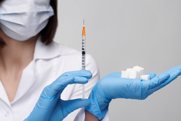 Diabetes,insulin,high blood sugar. Medical injection,diseases,health care.Doctor or nurse in hospital holding a syringe with liquid vaccines preparing to do an injection.People in white uniform,robe.