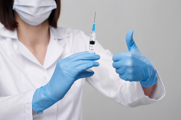 Medical injection,diseases,health care,science,diabetes.Doctor or nurse in hospital holding a syringe with liquid vaccines preparing to do an injection.Medical equipment. People in white uniform,robe.