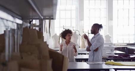 Two colleagues discussing in fashion office