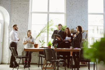 Second family. Group of young business professionals having a meeting. Diverse group of coworkers discuss new decisions, plans, results, strategy. Creativity, workplace, business, finance, teamwork.