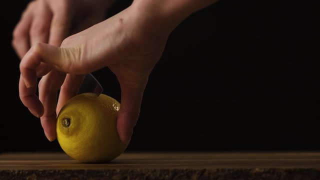 High quality food shot, hands, slicing lemon, ideal for imaging and under copy.