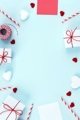 Valentine's Day, Mother's day art design concept for promotion - Red, white wrapped gift box isolated on pastel light blue color background, flat lay, top view.