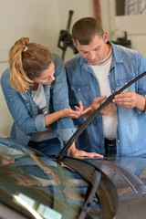 female and male worker picking up windscreen wiper