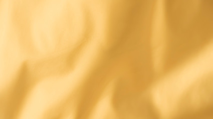 Smooth elegant yellow silk or satin luxury cloth texture background. Luxurious background design