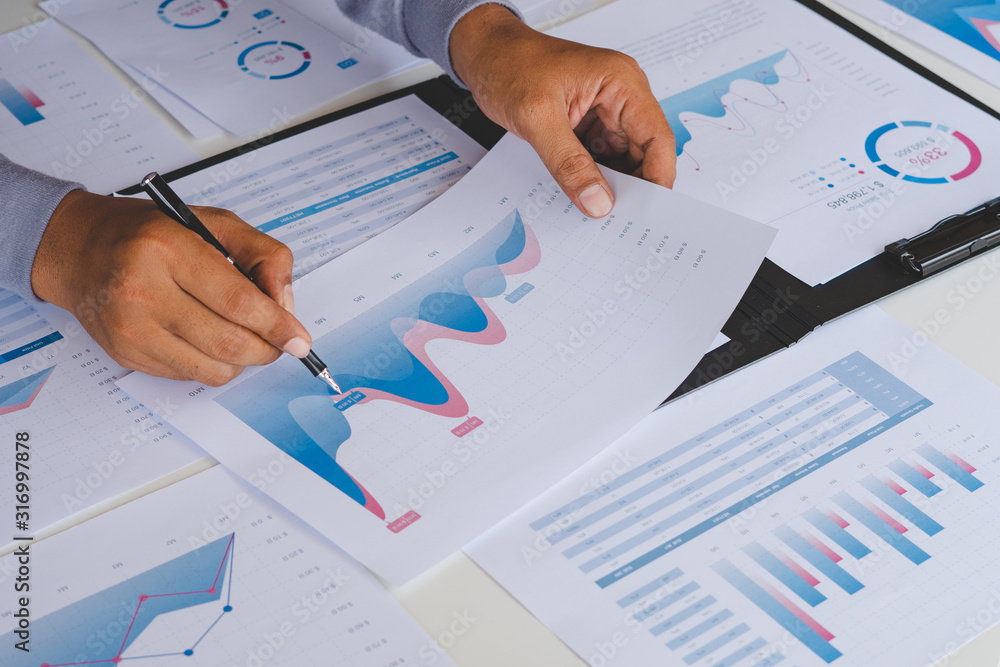 Aufkleber businessman working calculate data document graph chart report marketing research development planni