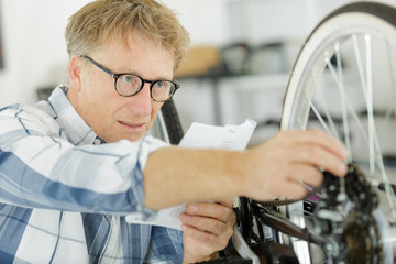 a male worker checking bike