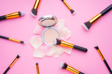 Obraz na płótnie Canvas Creative arrangement of cosmetics products on pink background.