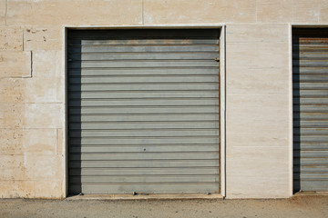 Obraz na płótnie Canvas metal garage door in the marble wall