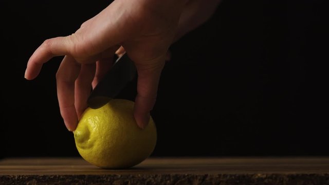 High quality food shot, hands, slicing lemon, ideal for imaging and under copy.