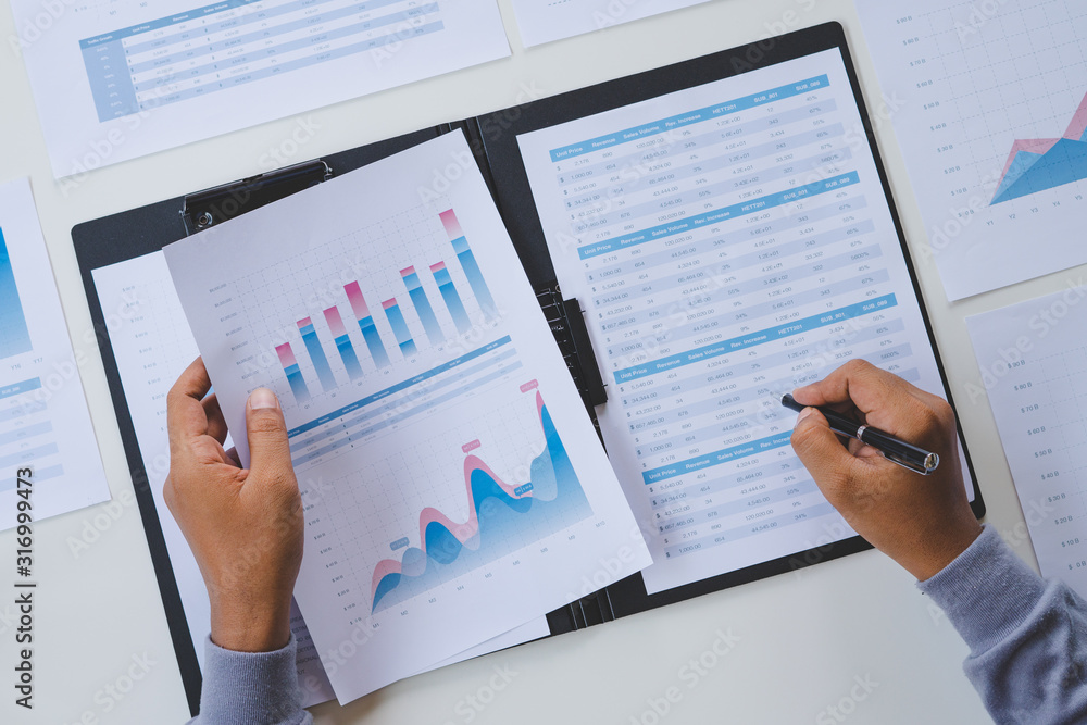 Aufkleber businessman working calculate data document graph chart report marketing research development planni
