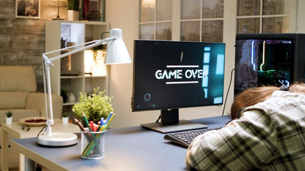 Man losing at shooter game while sitting on gaming chair