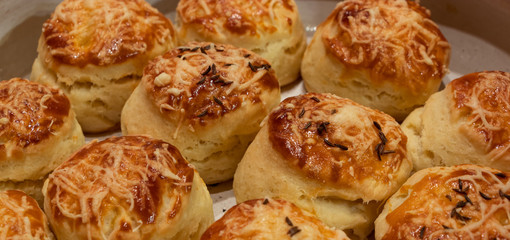 Close up of home baked traditional hungarian pastries pogacsa with cheese and cumin on top