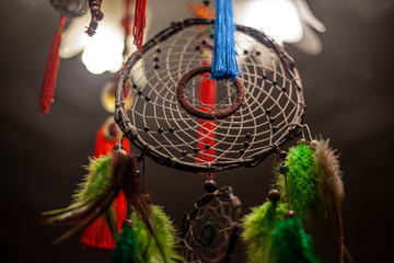 Dreamcatcher in the light of the lamp. The mystical doctrine of the idnians. Fractal weaving amulets. Belief in evil spirits abducting dreams. Remedy for insomnia. National sign. Home decoration.
