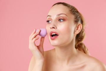 Close up blonde half naked woman 20s perfect skin blue eyes isolated on pastel pink wall background...