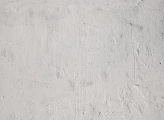 Fototapeta premium Texture of light gray stucco on the wall. Concrete wall covered with gray stucco.
