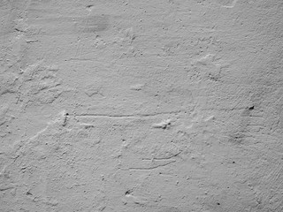 Obraz premium Old gray unevenly painted concrete wall. Texture of gray damaged plaster on the wall.