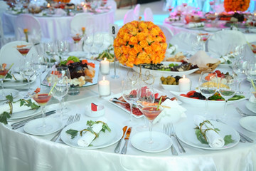 Holiday table setting decorated with flowers and candles.