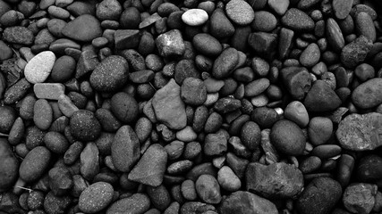 Fototapeta na wymiar black pebbles on the beach background