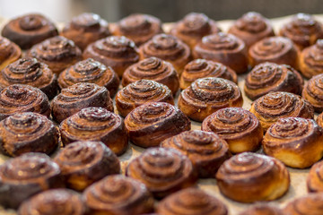 Roll cinnamon in a glaze of sugar syrup, baked, golden, and delicious.