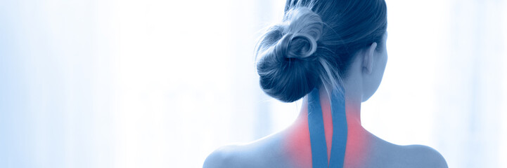 Female patient with kinesio tape on her neck against white background, rear view. Kinesiology,...