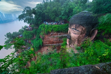 Ancient chinese pagoda covered by trees on the grounds in Leshan Mountain in Leshan Dafo Park, Leshan City in Sichuan province, China