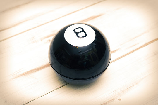 Magic Ball Of Predictions Figure Eight On A Light Wooden Background.