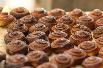 Roll cinnamon in a glaze of sugar syrup, baked, golden, and delicious.