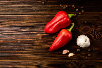 Red pepper and garlic on dark wooden background.