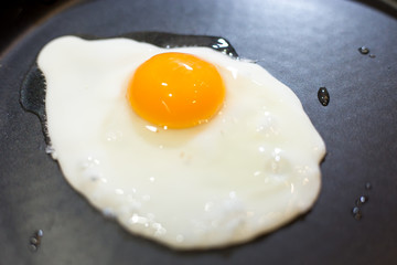 Scrambled eggs fried in a pan in the kitchen