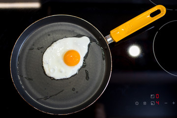Scrambled eggs fried in a pan in the kitchen