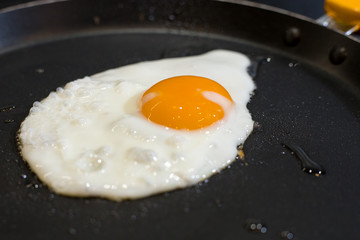 Scrambled eggs fried in a pan in the kitchen