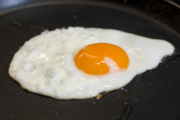 Scrambled eggs fried in a pan in the kitchen