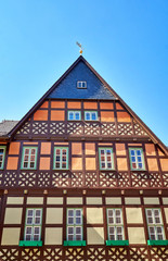 Old half-timbered house with small wooden windows.