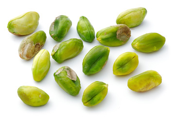 Heap of peeled pistachio nuts isolated