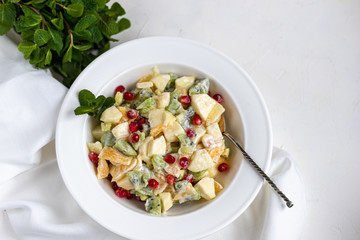 Diet fruit salad for breakfast. Kiwi orange banana and apple diced and seasoned with yogurt with honey. Healthy food, vegetarianism.