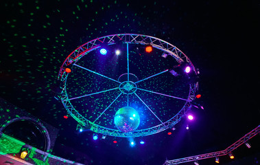 The disco ball with light rays in night club. Party background.